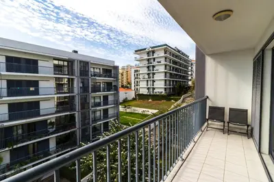 an apartment balcony with a view of two buildings at Acacia Apartment by Atlântica in Funchal