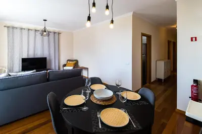 a living room with a table and a couch at Acacia Apartment by Atlântica in Funchal
