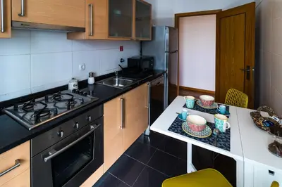a kitchen with a counter with a sink and a stove at Acacia Apartment by Atlântica in Funchal