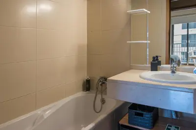 a bathroom with a sink and a bath tub at Acacia Apartment by Atlântica in Funchal