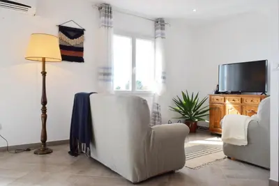 a living room with two chairs and a flat screen tv at Casa da Piedade, a Home in Madeira in Ponta do Sol