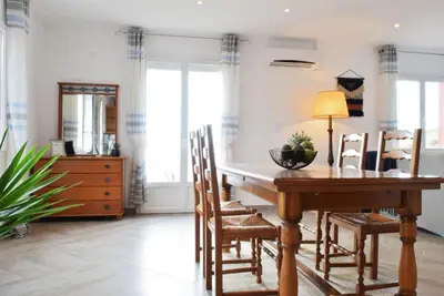 a dining room with a wooden table and chairs at Casa da Piedade, a Home in Madeira in Ponta do Sol