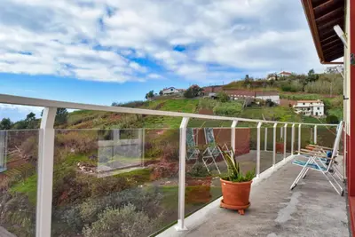 a balcony with a view of a hill at Casa da Piedade, a Home in Madeira in Ponta do Sol