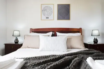 a bedroom with a bed with a blanket and two lamps at Casa da Piedade, a Home in Madeira in Ponta do Sol