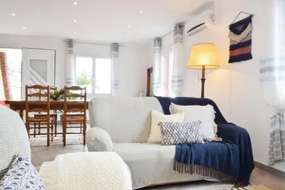 a living room with a blue and white couch at Casa da Piedade, a Home in Madeira in Ponta do Sol