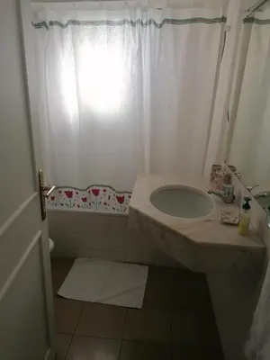 a bathroom with a sink and a shower curtain at Lido Funchal Apartment balcony sea view in Funchal