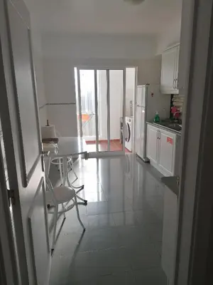 a kitchen with a table and chairs in a room at Lido Funchal Apartment balcony sea view in Funchal