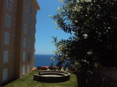 a view of the ocean from between two buildings at Lido Funchal Apartment balcony sea view in Funchal