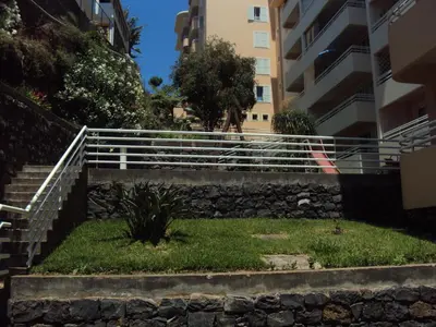 a set of stairs in front of a building at Lido Funchal Apartment balcony sea view in Funchal