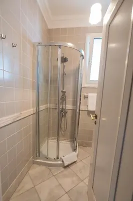 a shower with a glass door in a bathroom at Apartments Madeira in Caniço