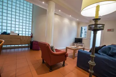 a living room with a couch and a floor lamp at Apartments Madeira in Caniço
