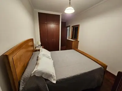 a bedroom with a wooden bed in a room at SAO PEDRO APARTMENT in Santa Cruz