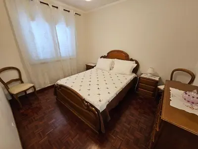 a bedroom with a bed and a table and a window at SAO PEDRO APARTMENT in Santa Cruz