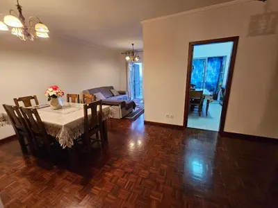 a dining room with a table and a living room at SAO PEDRO APARTMENT in Santa Cruz
