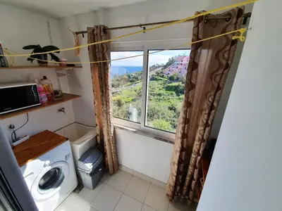 a bathroom with a window with a view of a mountain at SAO PEDRO APARTMENT in Santa Cruz