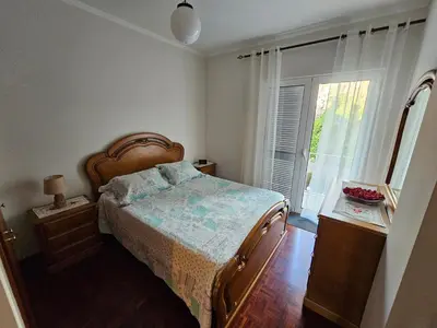 a bedroom with a bed and a large window at SAO PEDRO APARTMENT in Santa Cruz