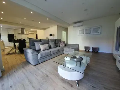 a living room with a couch and a table at Sunrise Glances & Free Parking in Funchal