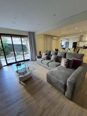 a large living room with a couch and a table at Sunrise Glances & Free Parking in Funchal