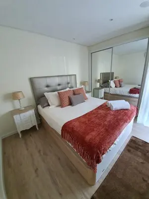 a bedroom with a large bed with a large mirror at Sunrise Glances & Free Parking in Funchal