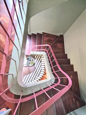 a spiral staircase with pink railings in a building at ASPA Studios - Urban Conscious Living in Funchal