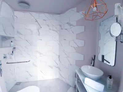 a white bathroom with a shower and a sink at ASPA Studios - Urban Conscious Living in Funchal