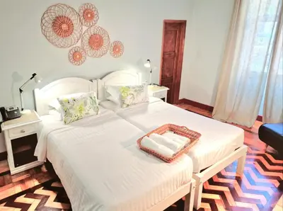 a bedroom with a white bed with a tray on it at ASPA Studios - Urban Conscious Living in Funchal