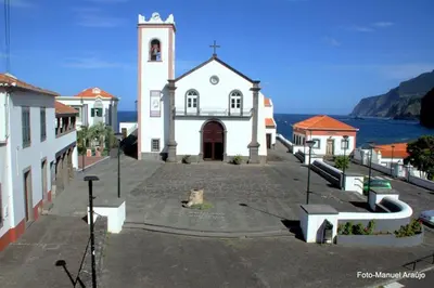a church with a clock tower in front of the water at PDelgada 3-Bed House Sleeps 6 Parking & Sea View in Ponta Delgada