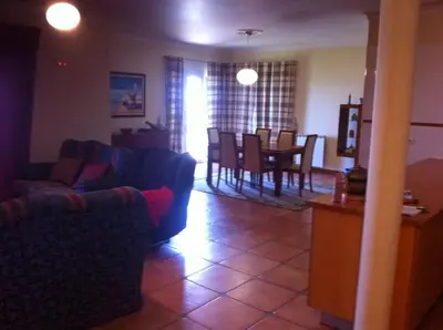 a living room with a couch and a dining room at PDelgada 3-Bed House Sleeps 6 Parking & Sea View in Ponta Delgada