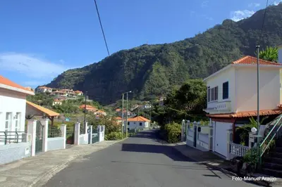 a street in a town with a mountain in the background at PDelgada 3-Bed House Sleeps 6 Parking & Sea View in Ponta Delgada