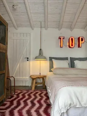 a bedroom with a bed and a top sign on the wall at Casa da Oliveira - Bordeira in Bordeira