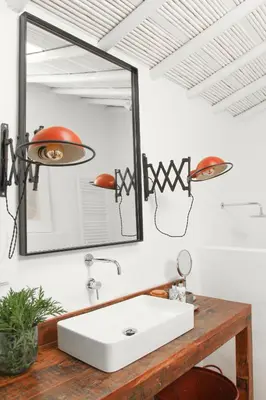 a bathroom with a white sink and a mirror at Casa da Oliveira - Bordeira in Bordeira