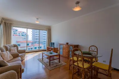 a living room with a couch and a table at FLH Funchal Balcony Apartment with Sea View in Funchal