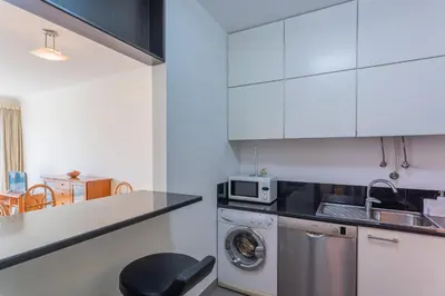 a kitchen with a sink and a washing machine at FLH Funchal Balcony Apartment with Sea View in Funchal