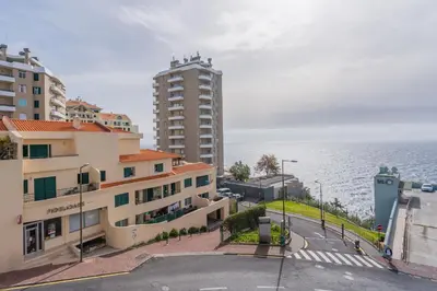 a view of the ocean from a building at FLH Funchal Balcony Apartment with Sea View in Funchal
