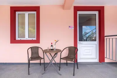 a table and chairs in front of a building at Comfortable apartment with shared pool in Prazeres, 150 m² in Campanário