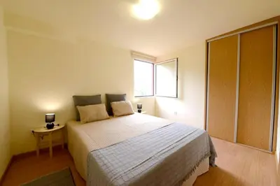 a bedroom with a large bed and a window at Charming Apartment in Prazeres with Shared Pool - 150 m² in Campanário