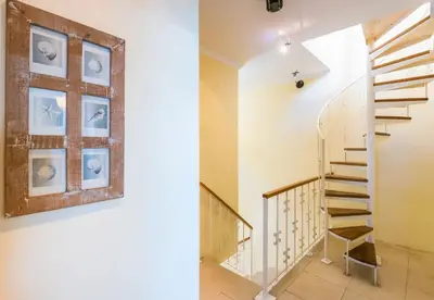 a staircase in a house with a picture on the wall at The Yellow House in Paul do Mar