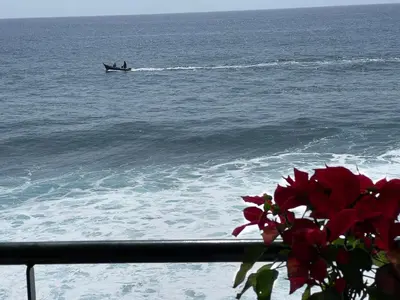 a boat in the ocean with a person in it at The Yellow House in Paul do Mar