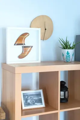 a wooden shelf with a picture and a clock at Casa Oceano-Ave do Mar in Raposeira