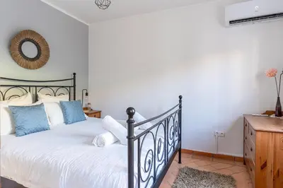 a bedroom with a black and white bed and a mirror at Casa Oceano-Ave do Mar in Raposeira