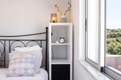 a bedroom with a bed and a window at Casa Oceano-Mar a vista in Raposeira