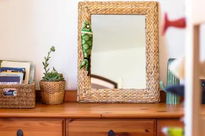 a mirror sitting on top of a wooden dresser at Casa Oceano-Mar a vista in Raposeira