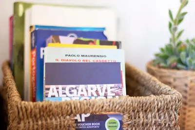 a wicker basket with books and magazines on a shelf at Casa Oceano-Mar a vista in Raposeira