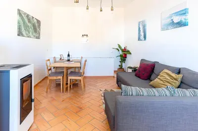 a living room with a couch and a table at Casa Oceano-Mar a vista in Raposeira