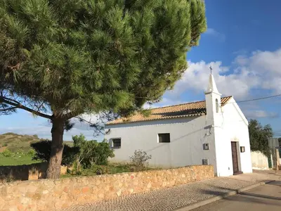 a white church with a tree in front of it at Casa Oceano-Mar a vista in Raposeira