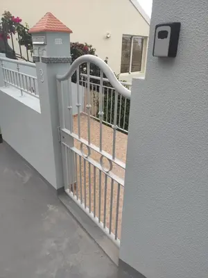 a white fence with a gate on a house at Bluegreen in Arco da Calheta