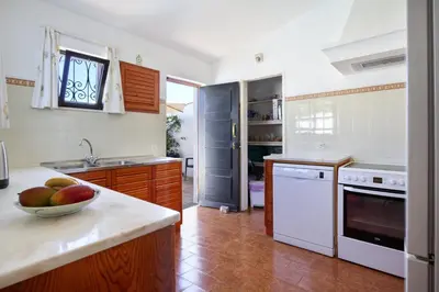 a kitchen with a bowl of fruit on a counter at Villa Mirembe in Luz