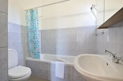 a bathroom with a sink and a toilet and a tub at Villa Mirembe in Luz