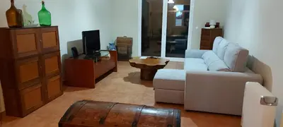 a living room with a couch and a tv and a table at Avó Lucindinha House - Porto Moniz in Porto Moniz