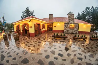 a building with a patio with couches in front of it at Quinta da Moscadinha in Camacha